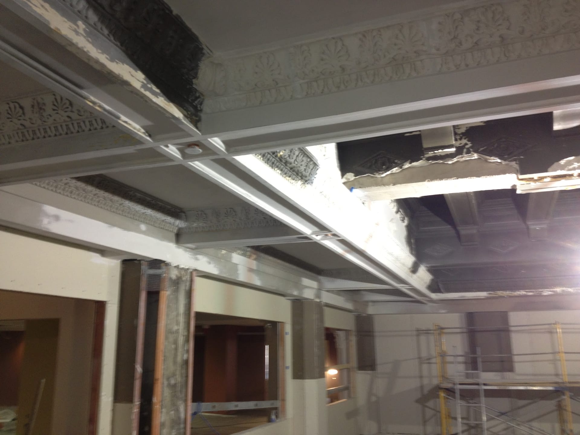 Historic decorative plaster ceiling partially removed during interior renovation work