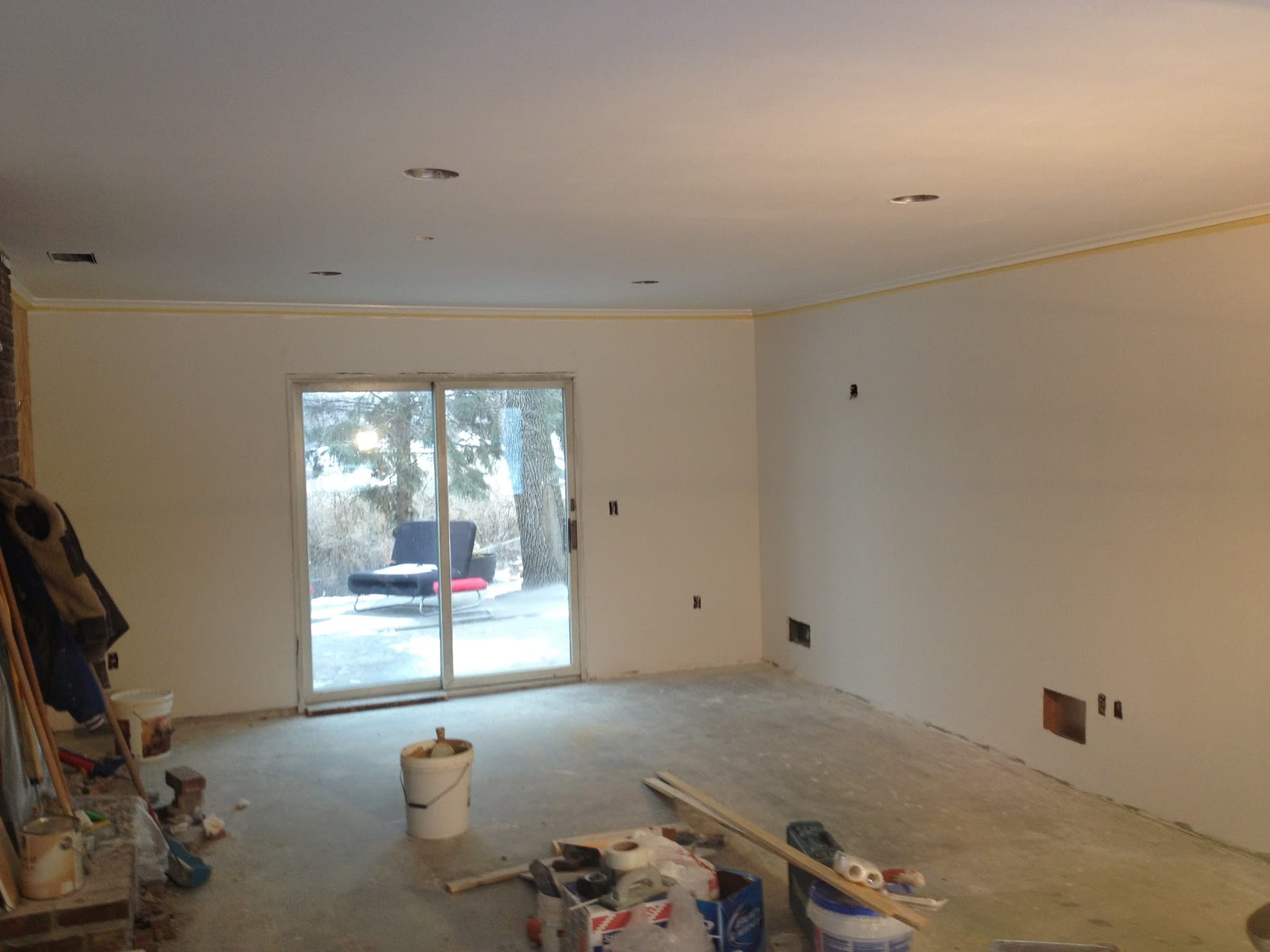 Freshly plastered interior walls and ceiling in an empty room under renovation