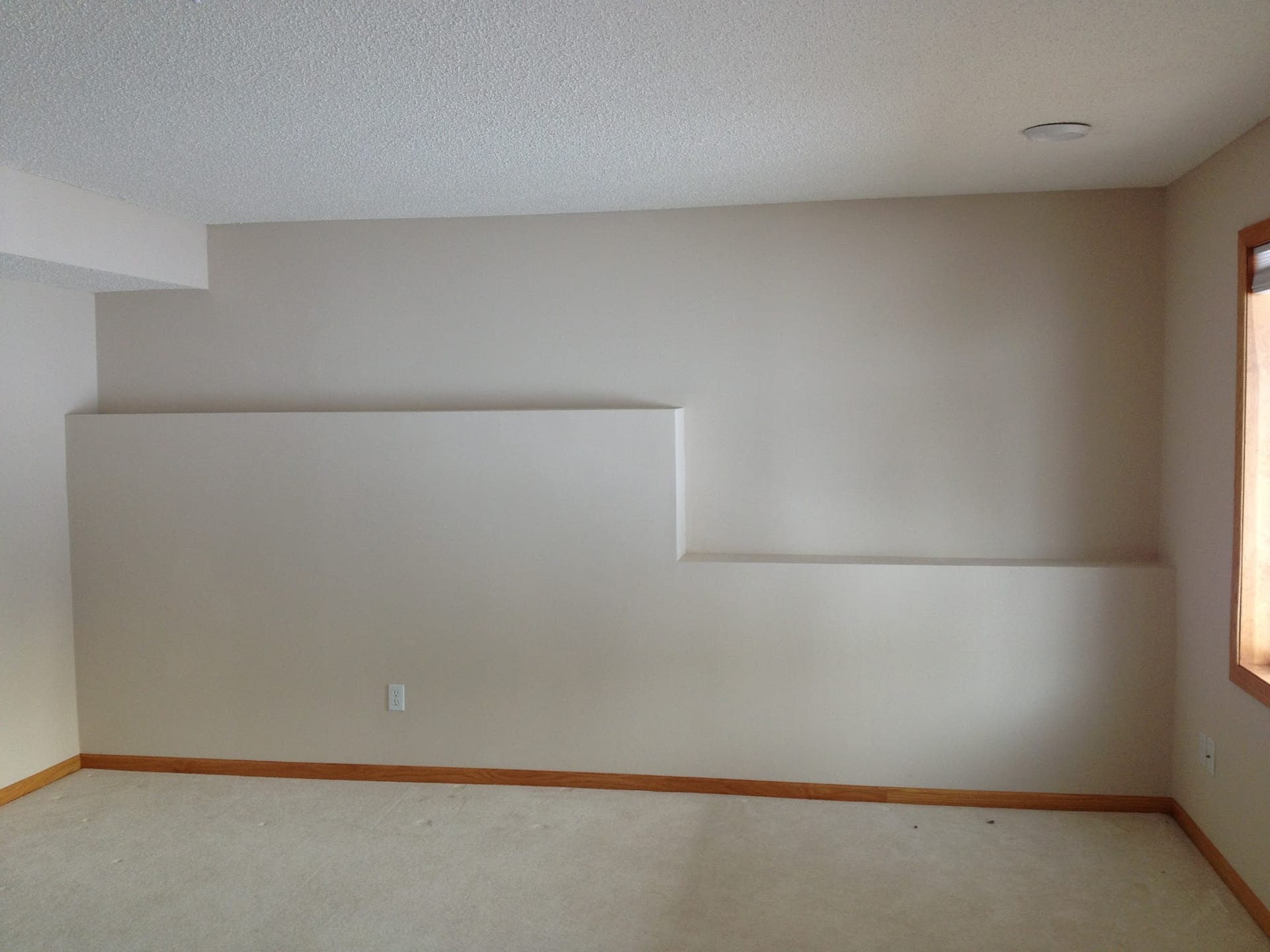 Smooth interior plaster walls with built-in shelving in empty room