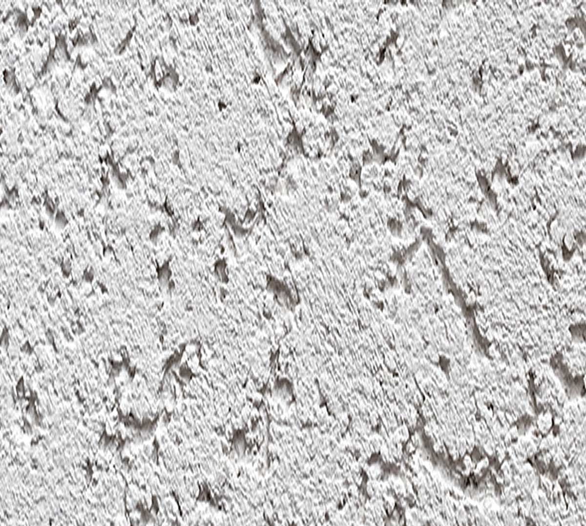 Close-up of rough white stucco finish texture on exterior wall